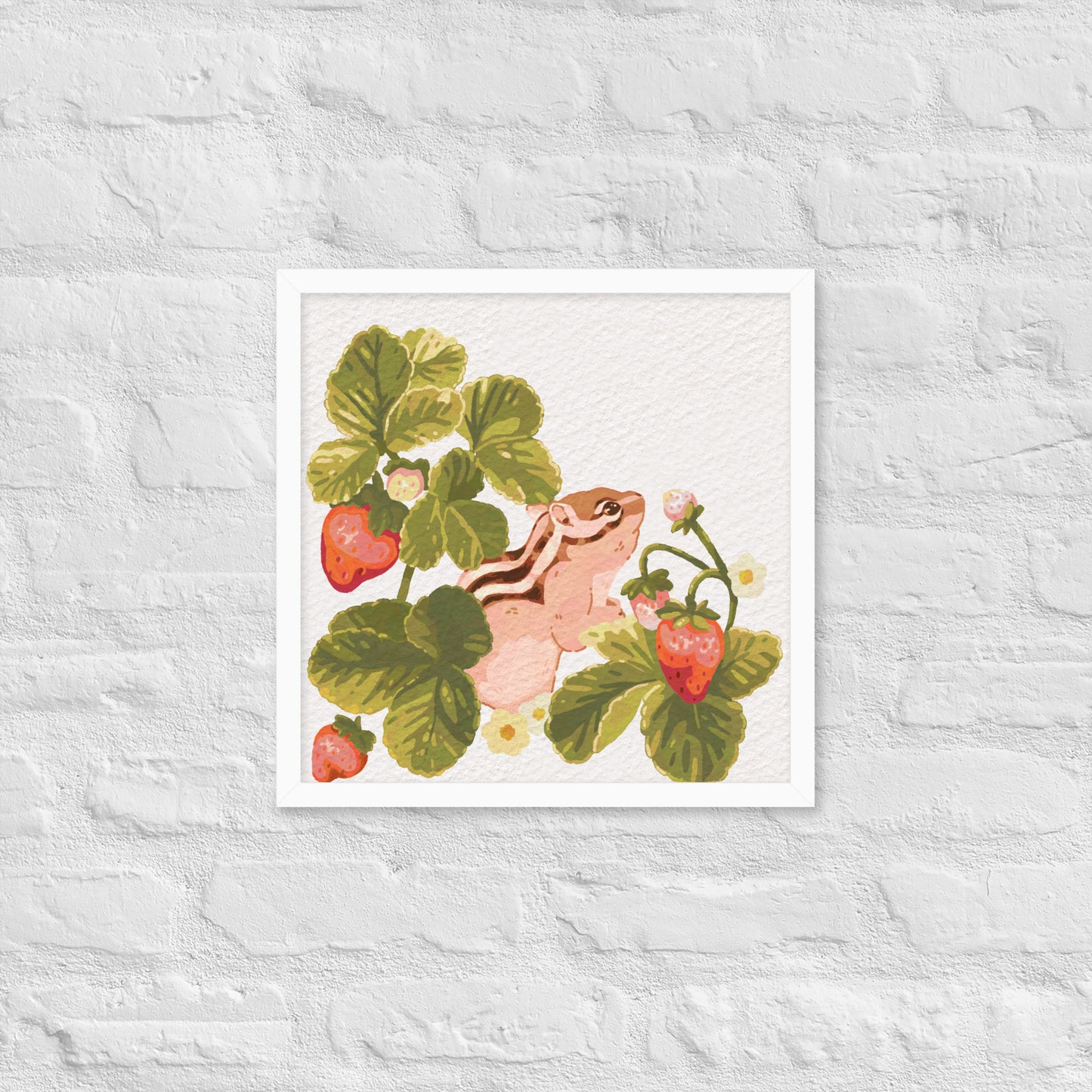 Framed artwork of a chipmunk among strawberry plants on a textured white wall.
