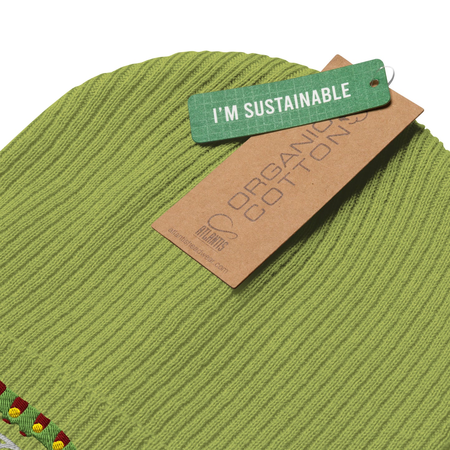 Green fabric with a 'I'm Sustainable' tag on a white background