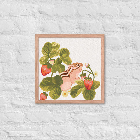 Framed artwork of a chipmunk among strawberry plants on a textured white wall.