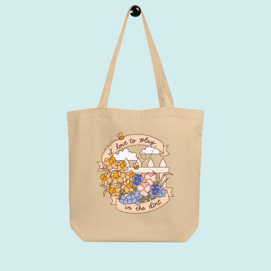 Beige tote bag with floral design and text on a light blue background