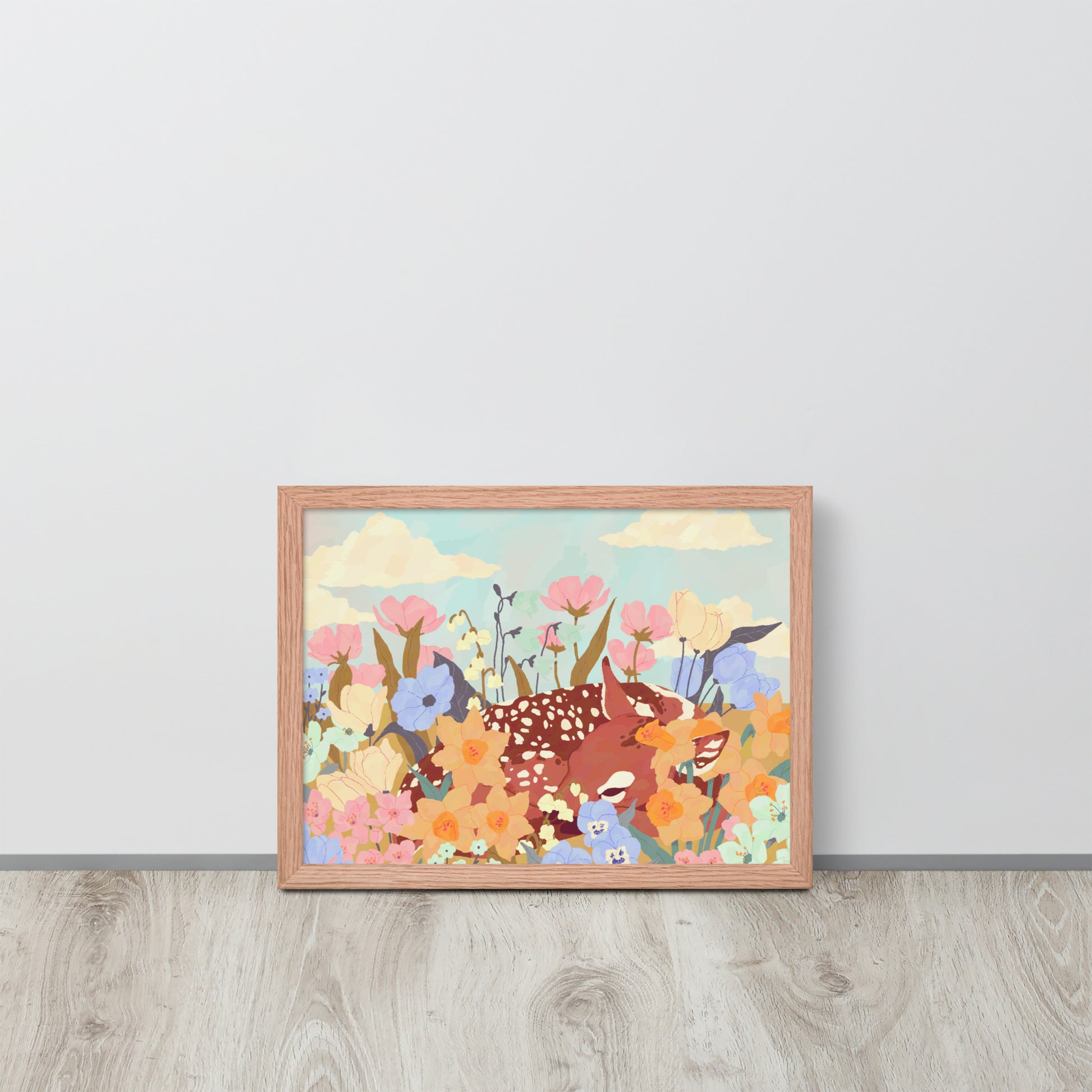 Framed artwork with colorful animals and flowers on a light gray wall.