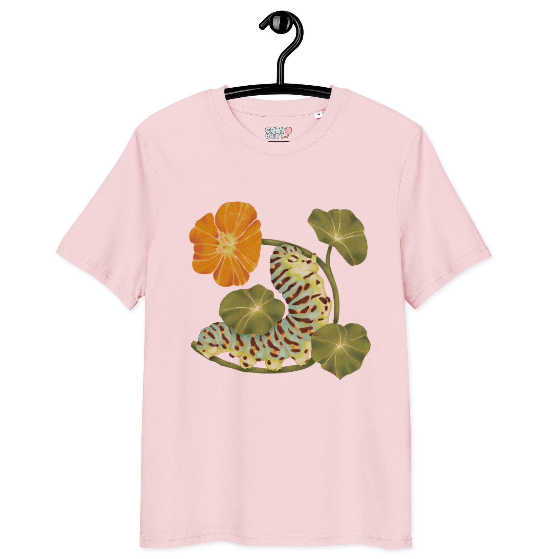 Pink t-shirt with floral design on a hanger against a white background