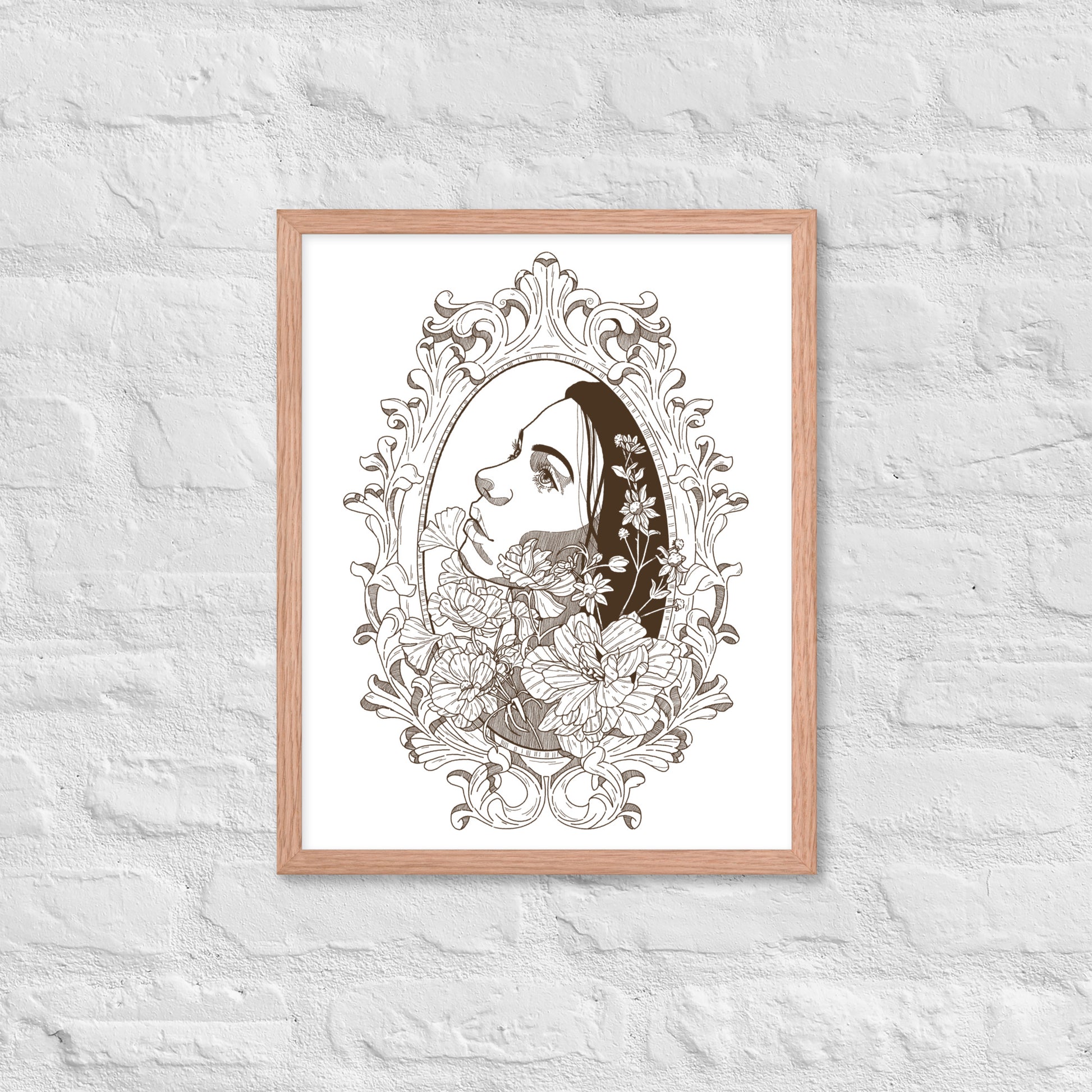 Framed artwork of a woman's profile with floral elements on a white wall.