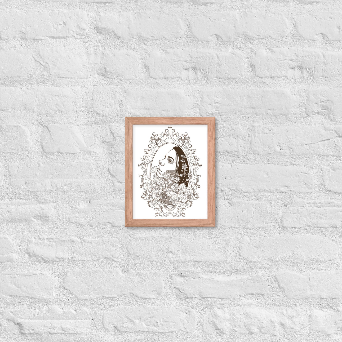 Framed artwork of a woman's face with floral elements on a textured white wall.