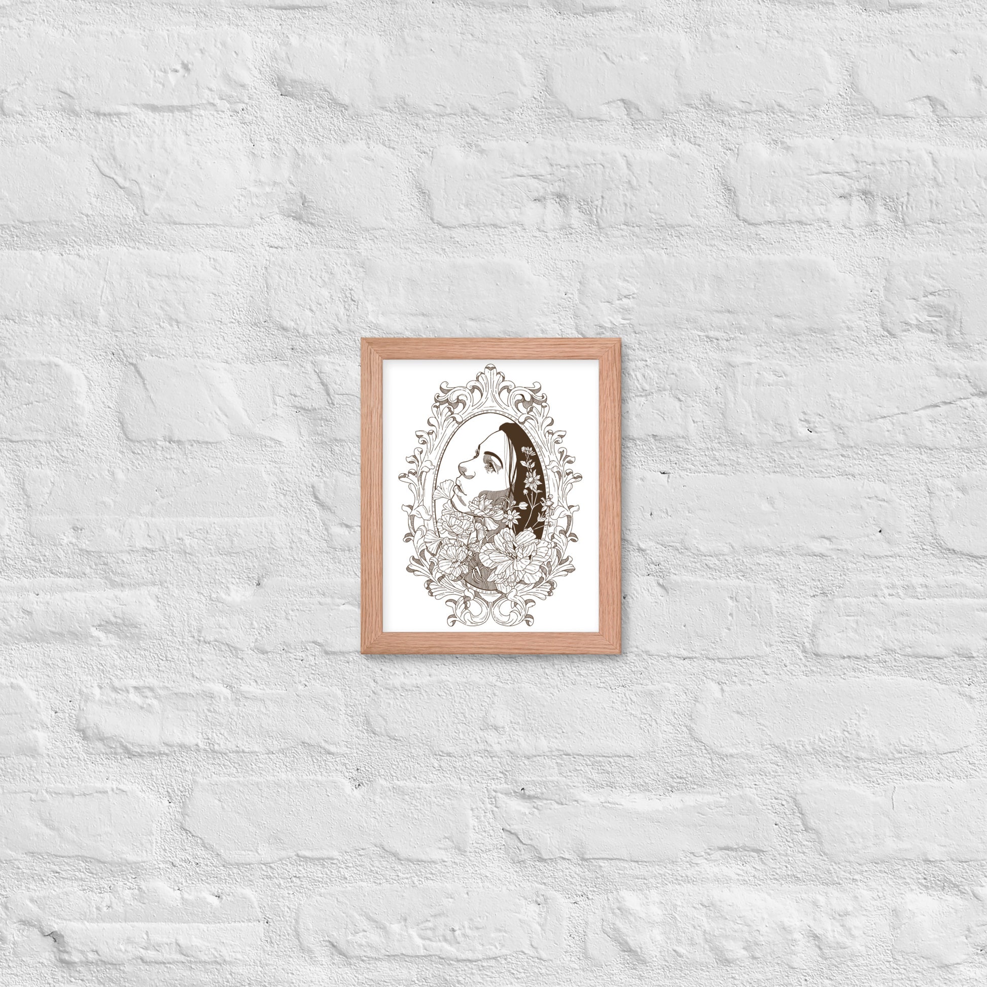 Framed artwork of a woman's face with floral elements on a textured white wall.